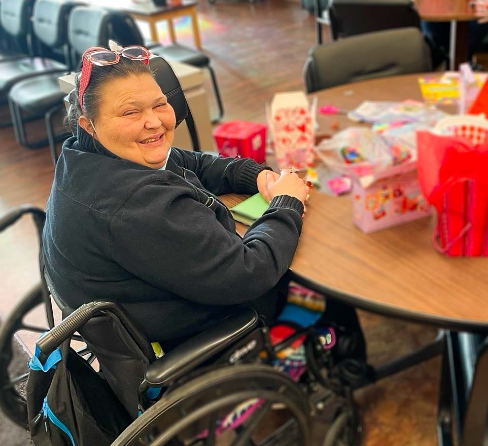 More-Than-40-Years-of-Compassionate-Care-in-Spokane Spokane Transitions lady in wheel chair at a table smiling