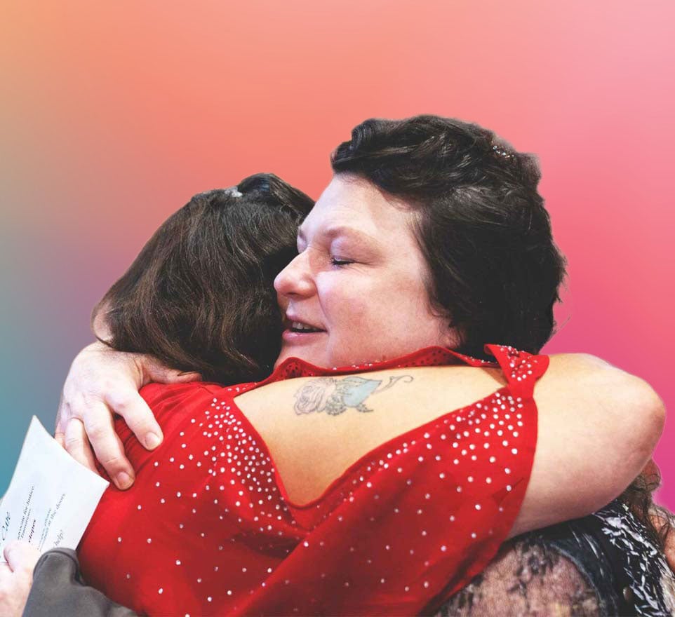 A couple women hugging at Transitions