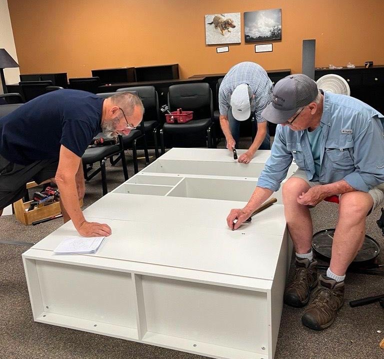 Your-Time-Can-Help-Create-Hope volunteers for Transitions putting together a cabinet